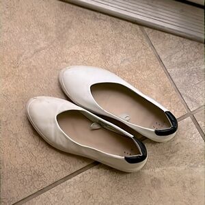 White flats with black heel- worn but good condition. Size 7 W